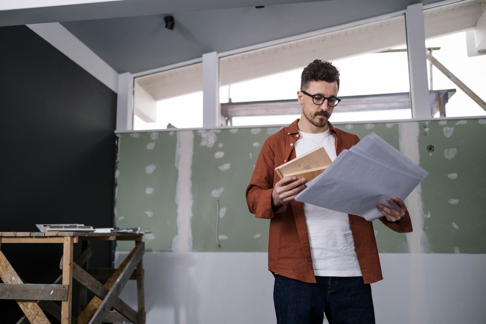 A contractor reviewing construction plans
